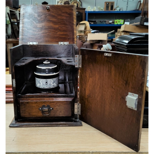 138 - A 1930's oak, smokers cabinet with jar.