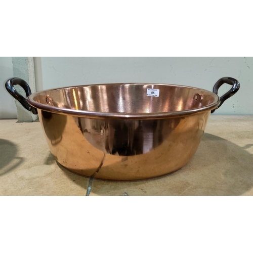 85 - A 19th century copper jam pan; a brass footman