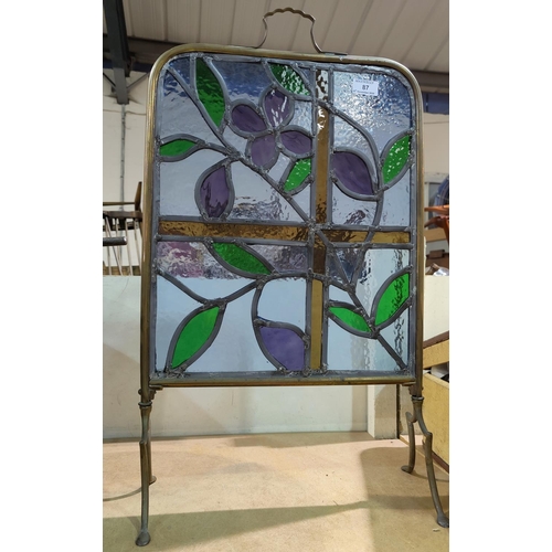 87 - A coloured and leaded brass firescreen