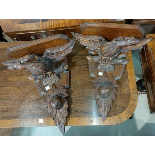 90 - A 19th pair of Black Forest wall brackets carved as eagles