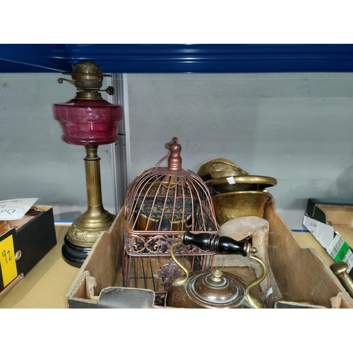 101 - A 19th century brass oil lamp with cranberry reservoir; a copper kettle; brassware