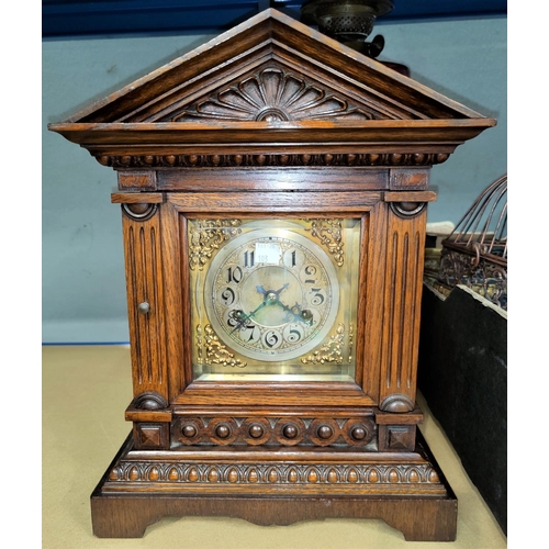 103 - An Edwardian mantel clock in architectural oak case, with strike