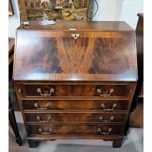 632 - A Reprodux mahogany bureau with fall front and 4 drawers