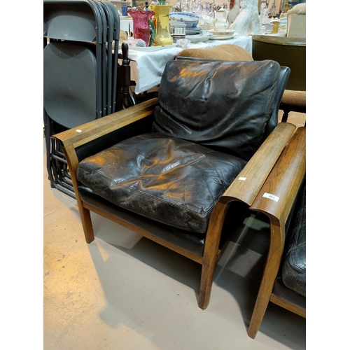 483 - A Danish rosewood framed lounge suite comprising 3 seater settee and 2 armchairs, with black leather... 