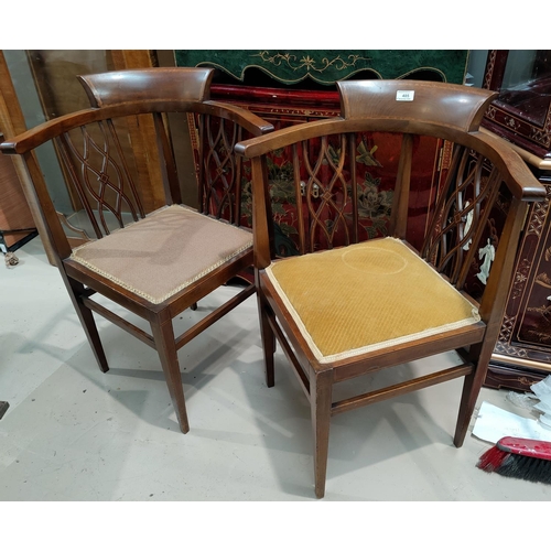 485 - An Edwardian pair of tub shaped corner armchairs in crossbanded mahogany