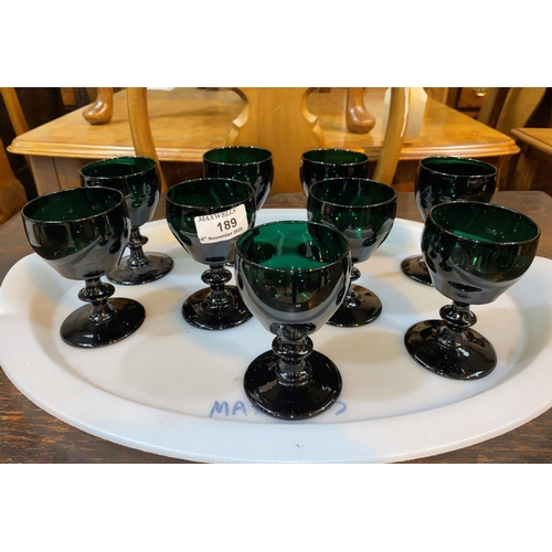 189 - A set of 9 ogee shaped green wine glasses