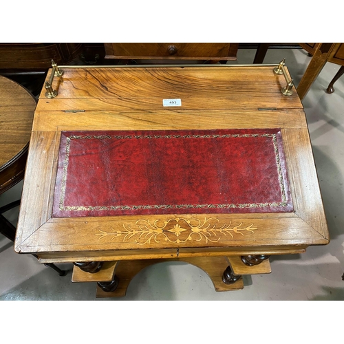 493 - A Victorian inlaid walnut writing desk with slope front, leather inset flap, and 2 open shelves unde... 