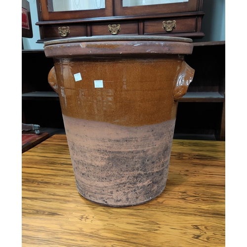 154 - An early 20th century terracotta bread crock with riveted wooden cover 42 cm high