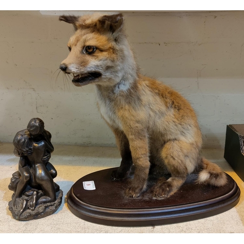 9 - A vintage taxidermy fox cub on stand and a bronzed group Adam and Eve