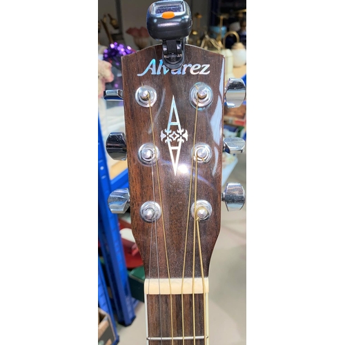 41 - An Alvarez steel strung (strung left handed) acoustic guitar with stand & tuner