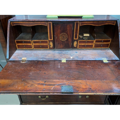 484 - A Georgian crossbanded mahogany bureau with fall front fitted interior, 3 long and 2 short drawers w... 