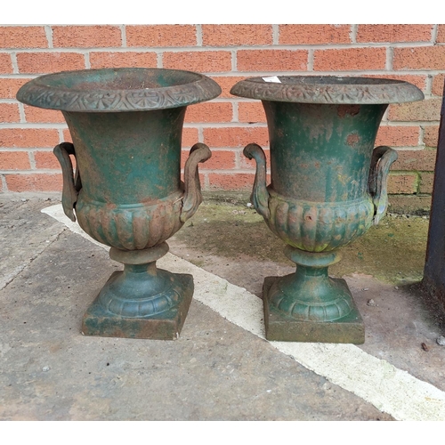 1 - A pair of cast iron garden urns in the classical style with antique green finish