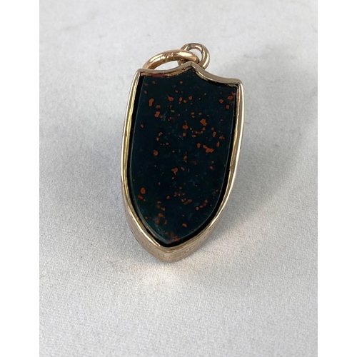 285 - A Victorian watch fob in the form of a shield set on both sides with coloured agate in yellow metal ... 