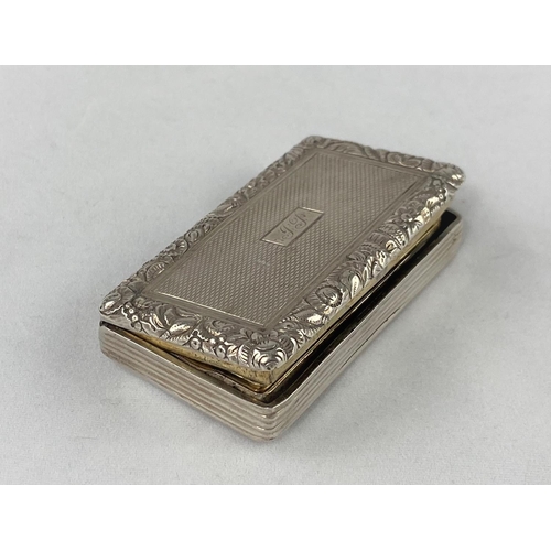 311 - A large rectangular engine turned silver vinaigrette with embossed floral border, gilded interior an... 