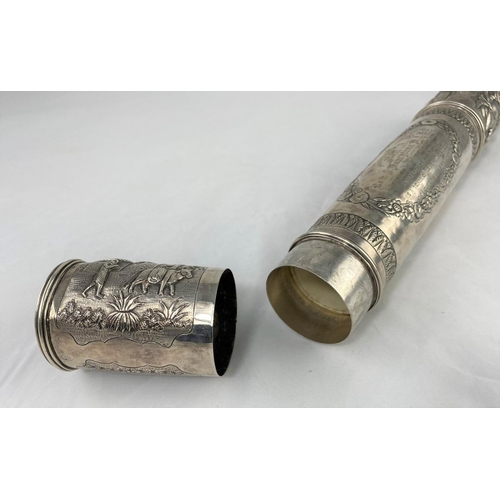 312 - An Indian white metal scroll tube with decoration in relief and with presentation inscription to the... 