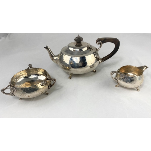 328 - A 3-piece planished Arts and Crafts hallmarked silver tea service comprising tea pot, milk jug and s... 