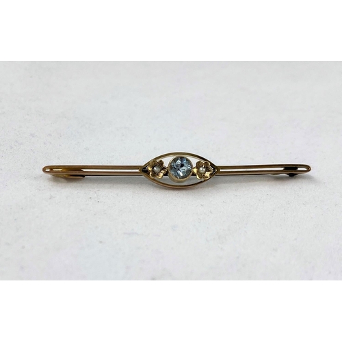 335 - A yellow metal bar brooch set aquamarine coloured stone, flanked by 2 floral set seed pearls, stampe... 