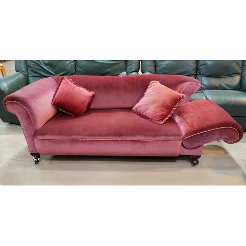 466 - An early 20th century drop arm three seater settee, covered in pink draylon velvet and a pair of mat... 