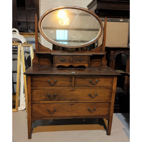 469 - A 1920's mahogany Georgian style dressing chest with oval swing mirror, 107cm