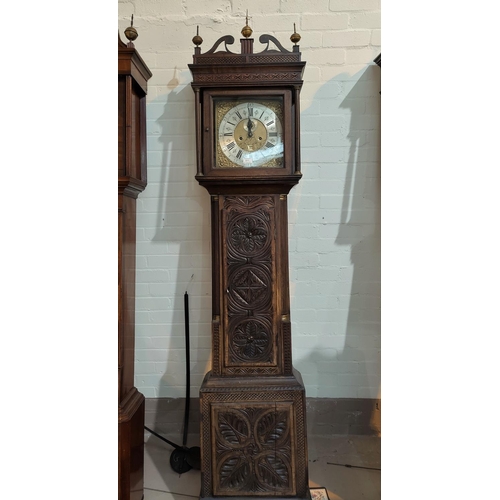 511 - An 18th century oak longcase clock with later carved decoration, having fretted swan neck pediment, ... 
