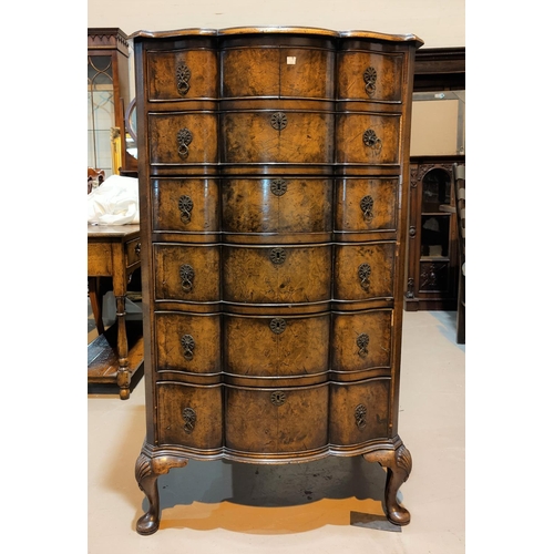 565 - A late 19th/early 20th century burr walnut 6 height chest of drawers in the Queen Anne style with se... 