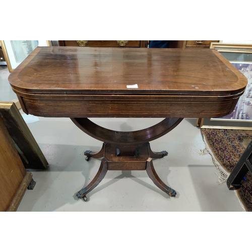 577 - A Regency period crossbanded rosewood card table with fold-over rounded rectangular top, baize lined... 