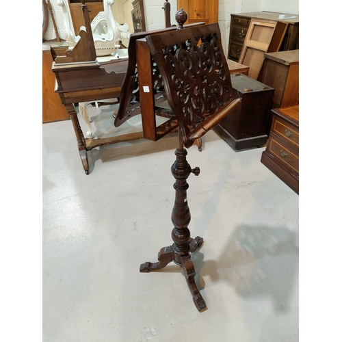 671 - A 19th century fretwork adjustable double sided music stand, on turned baluster column and triple sp... 