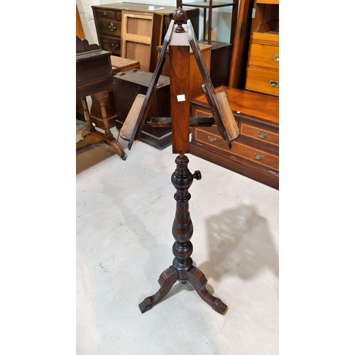 671 - A 19th century fretwork adjustable double sided music stand, on turned baluster column and triple sp... 