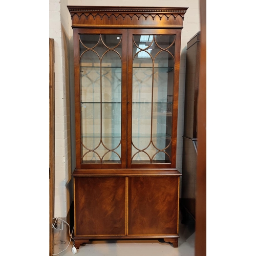 679 - A Georgian style crossbanded mahogany full height bookcase with twin glazed doors over double cupboa... 