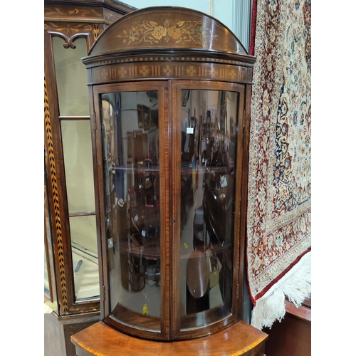 689 - An Edwardian mahogany full height bow front corner display cabinet with extensive floral marquetry i... 