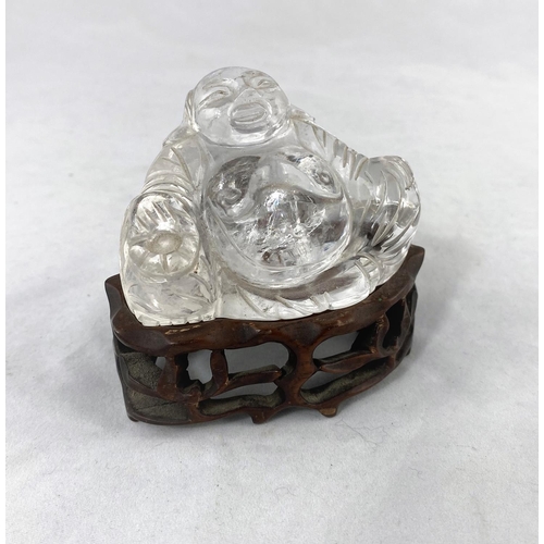 153 - A Chinese rock crystal carving of a seated buddha on wooden base, height 3.5cm, height on base 7cm