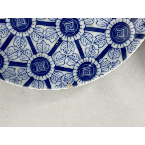 155 - A Japanese blue and white finely decorated bowl with flowers and dragons, diameter 14cm; a similar b... 