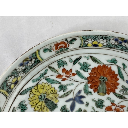 158 - A Chinese famille verte charger decorated with flowers etc, bearing old metallic repairs, diameter 2... 