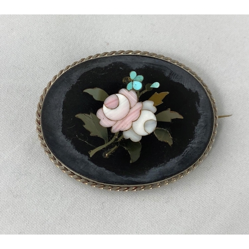 294 - A vintage oval pietra dura floral design brooch in white metal frame, tests as silver
