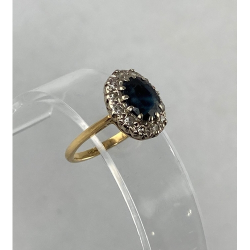 295 - A lady's dress ring set central sapphire and 12 diamond surround, yellow metal shank stamped '18ct',... 