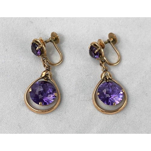 302 - A pair of yellow metal earrings test 14ct comprising of an amethyst with larger round amethyst in sw... 