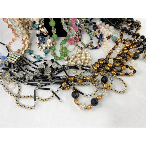 361 - A large selection of decorative bead and other costume necklaces from the mid 20th century