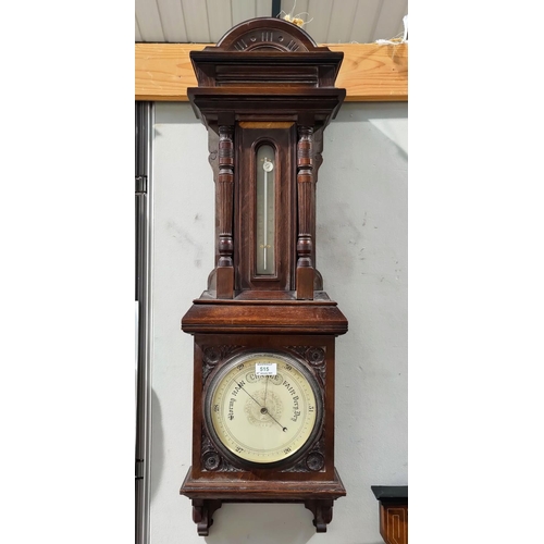 515 - An early 20th century large barometer with thermometer, in wall hanging oak case with turned side pi... 