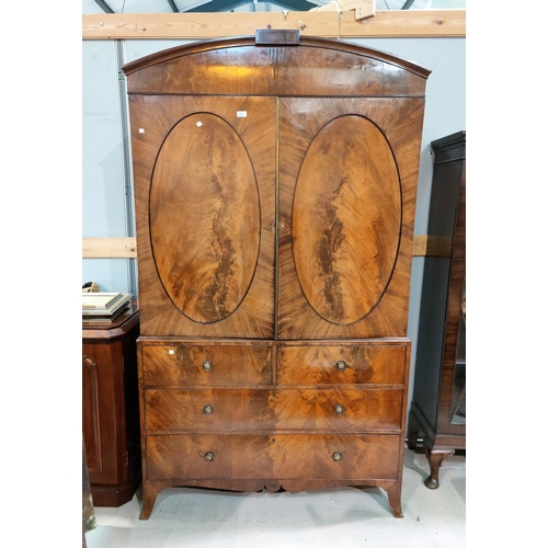 553 - A late Georgian figured mahogany press cupboard, the upper section with arch top and 4 sliding trays... 