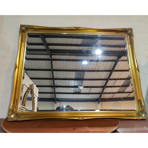 683 - A large bevelled edge wall mirror in rectangular gilt frame, length 137 cm