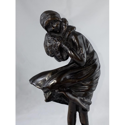 439 - A modern bronze figure in the Art Deco style, woman with muff on a windy day, height 38 cm