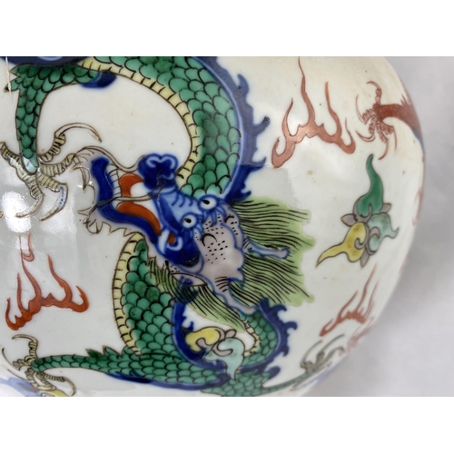 199 - A large Chinese baluster vase decorated with red and burnt orange  dragons and characters, height 32... 