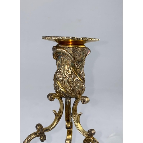 395 - A mid 20th century pair of Irish silver candlesticks in the rococo style, having scrolled supports o... 