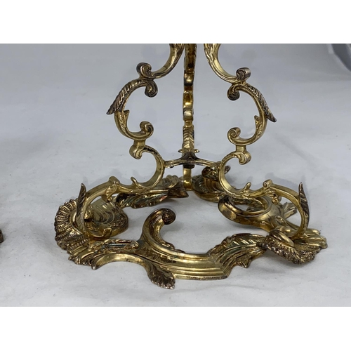 395 - A mid 20th century pair of Irish silver candlesticks in the rococo style, having scrolled supports o... 