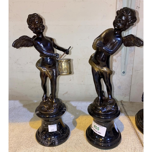 455 - A pair of modern bronze figures:  cherubs with drum and cymbals respectively, on grey marble pedesta... 