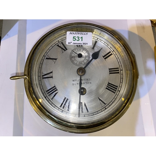531 - A ships clock in cylindrical brass case, with silvered dial, by Wm Jenkins, Dumbarton, diameter 18 c... 