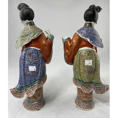 164a - A pair of finely decorated ceramic Chinese women in traditional clothing, height 30cm, both a.f.