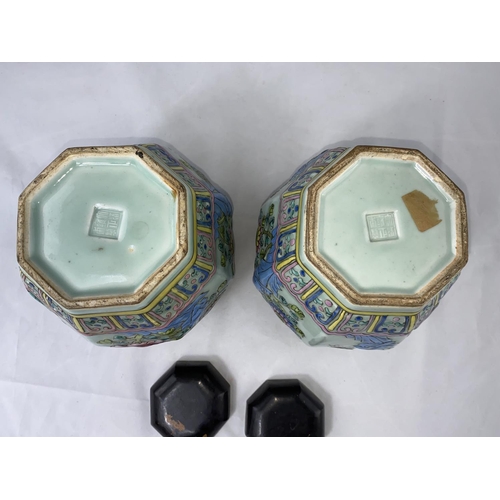 175 - A Chinese pair of octagonal jars, celadon glaze with raised polychrome decoration in the famille ros... 