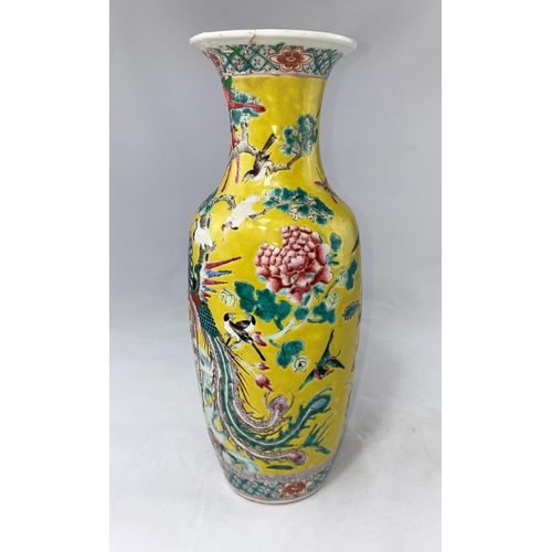 176a - A Chinese baluster vase with intricate enamel famille jaune decoration of birds, flowers and foliage... 