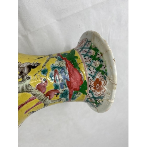 176a - A Chinese baluster vase with intricate enamel famille jaune decoration of birds, flowers and foliage... 